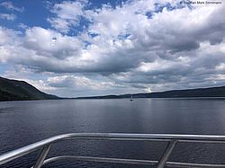 Blick auf den schottischen Süßwassersee Loch Ness an einem windstillen Sommertag